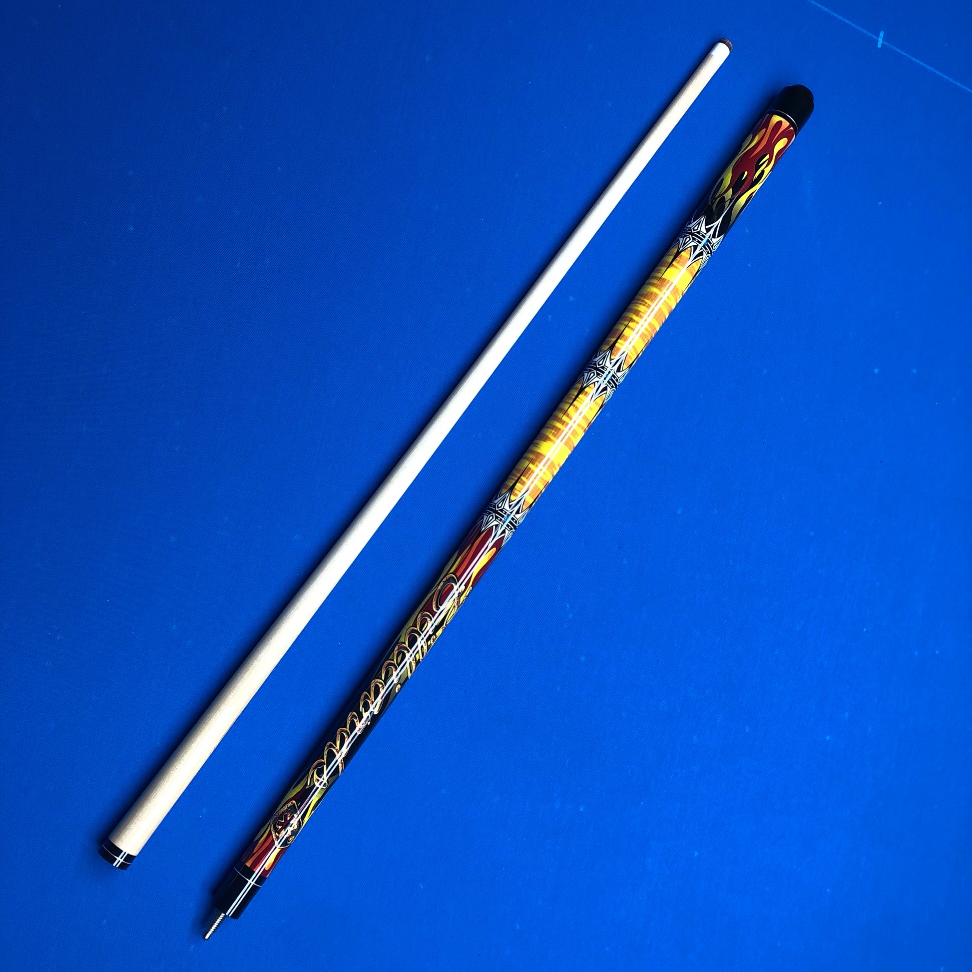 Decorative pool cue with a white shaft and colorful handle on a blue background