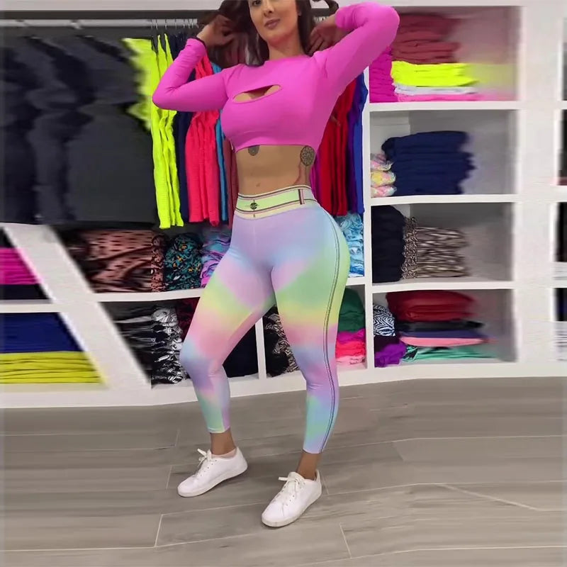 Person wearing a pink top and colorful leggings in a room with shelves of clothes.