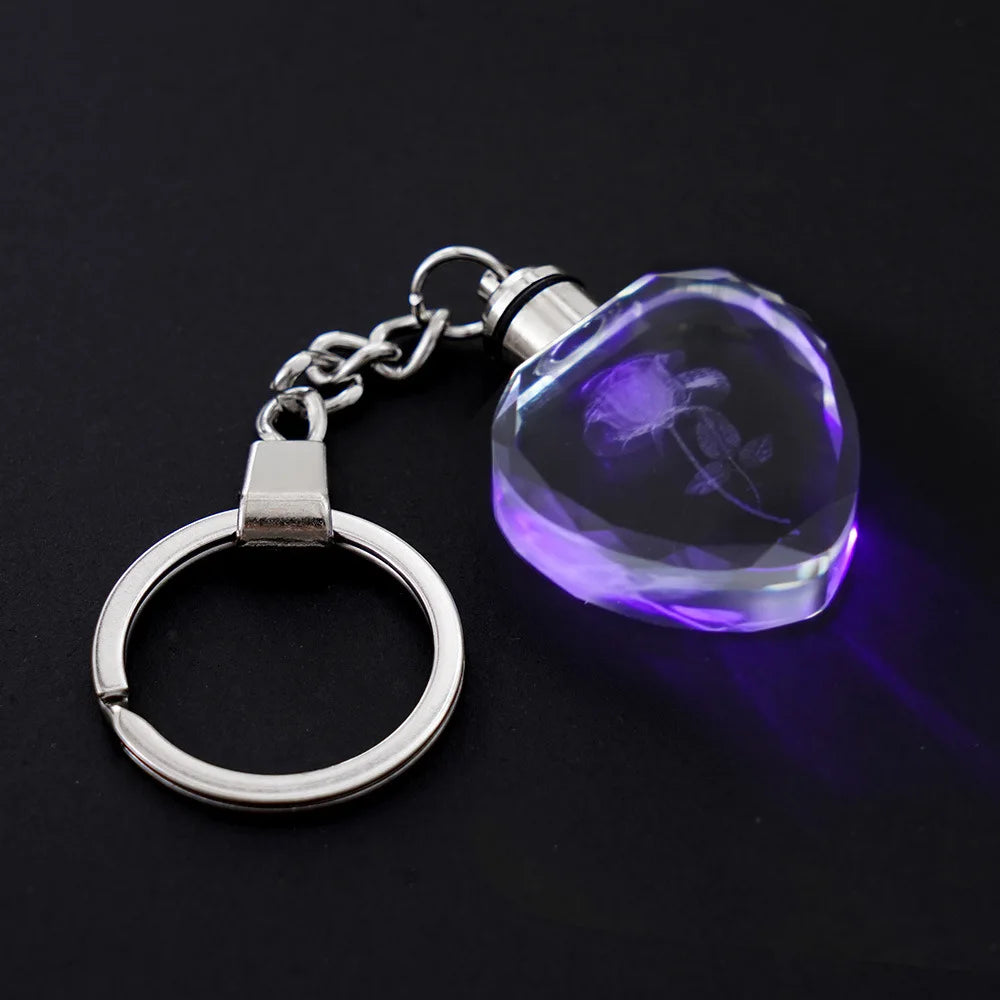 Keychain with a heart-shaped LED light on a black background