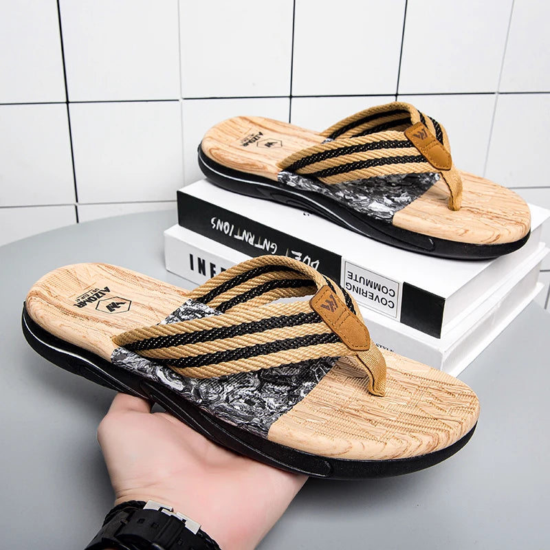 Pair of wooden sandals with black straps on a white surface.