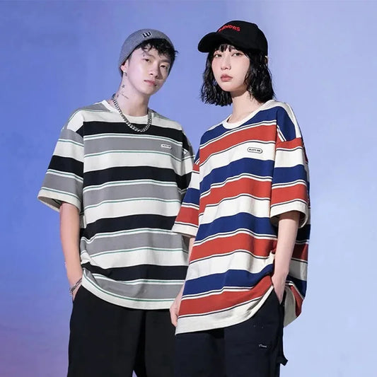 Two people wearing striped shirts against a blue background