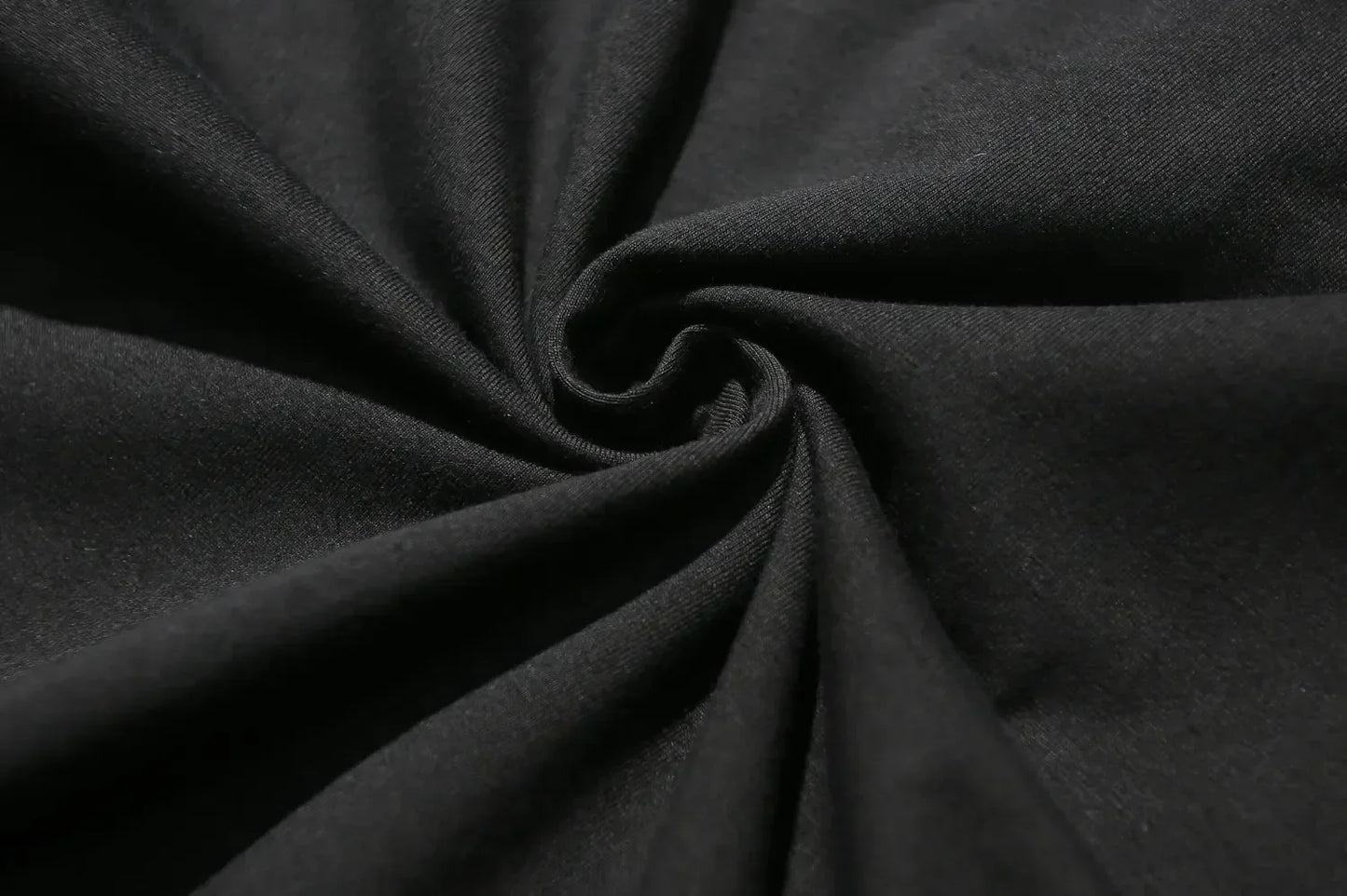 Close-up of dark gray fabric with folds