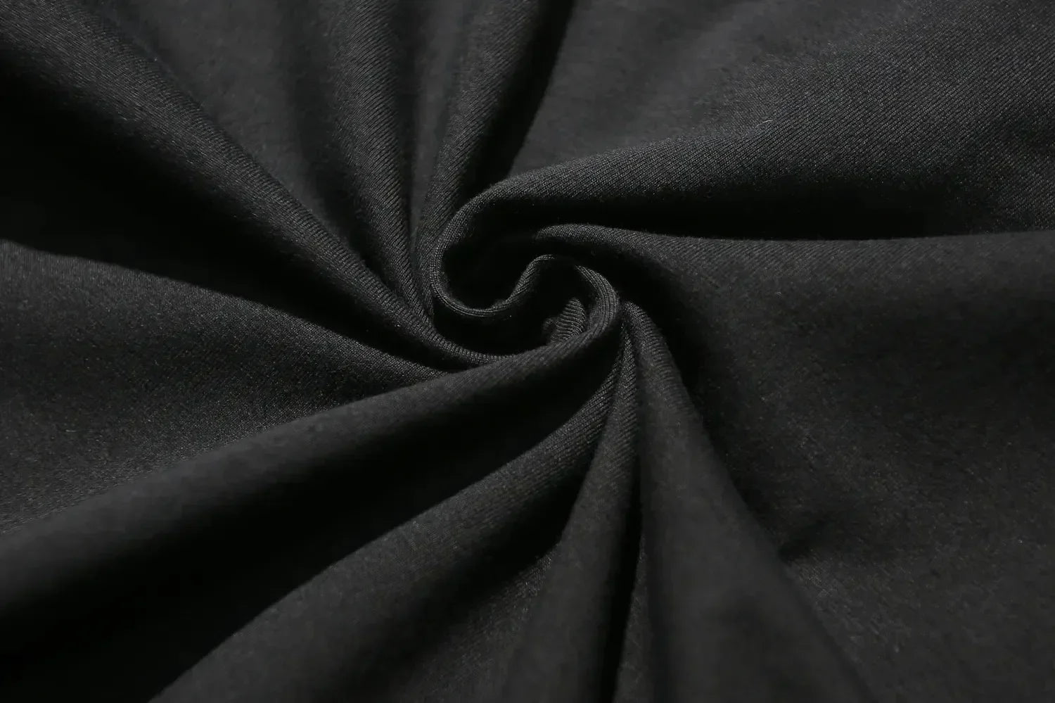 Close-up of dark gray fabric with folds