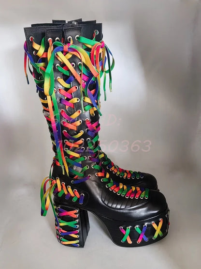 Black knee-high boot with colorful laces on a gray background