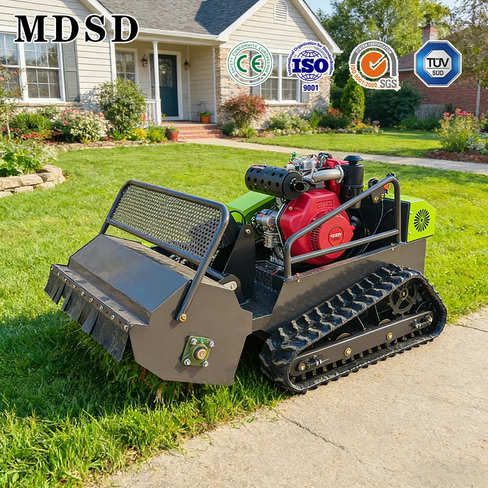 Small tracked machine on grass with a house in the background
