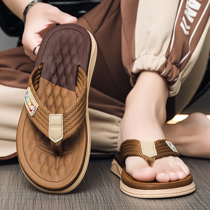 Brown sandals being worn with a focus on the sole and design.