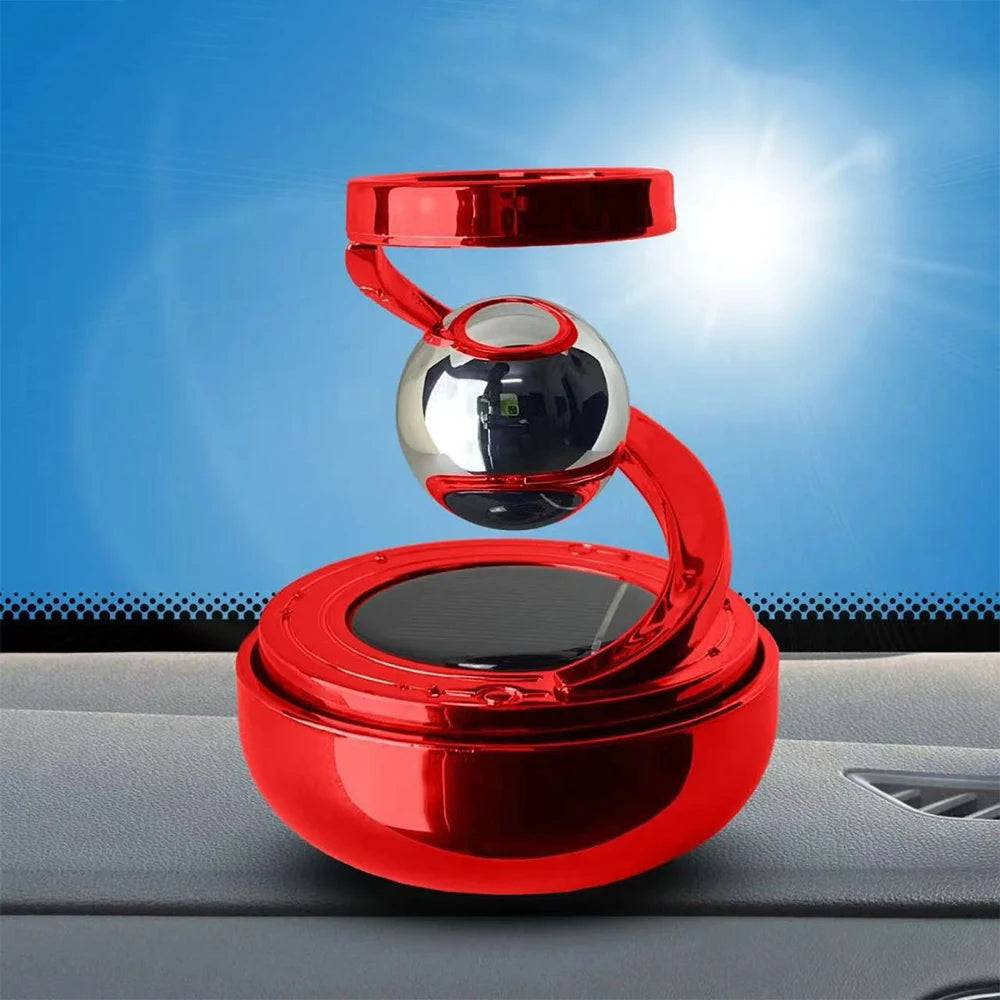 Red and silver floating device on a car dashboard with a blue sky background
