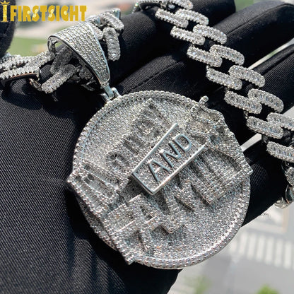 Silver chain necklace with a pendant on a black background