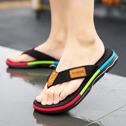 Black sandals with colorful straps worn on a reflective surface