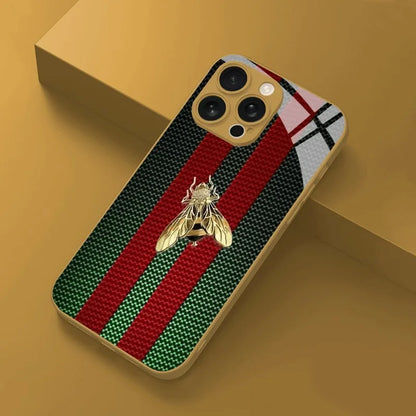 Phone case with red and green striped pattern and gold bee design on a yellow background