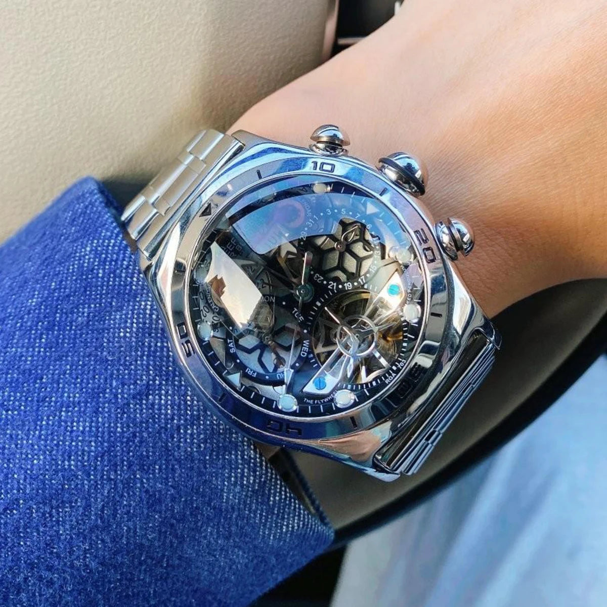 Luxury watch with intricate design on a wrist, close-up shot.