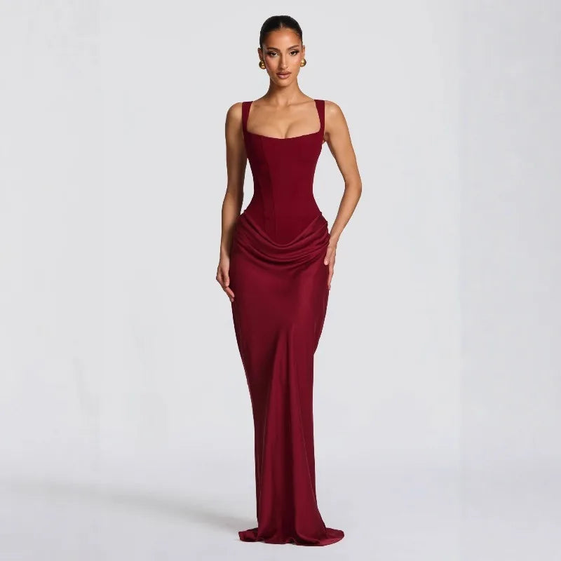 Woman wearing a burgundy evening gown on a white background