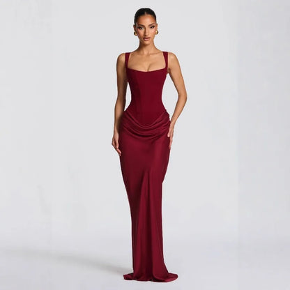 Woman wearing a burgundy evening gown on a white background