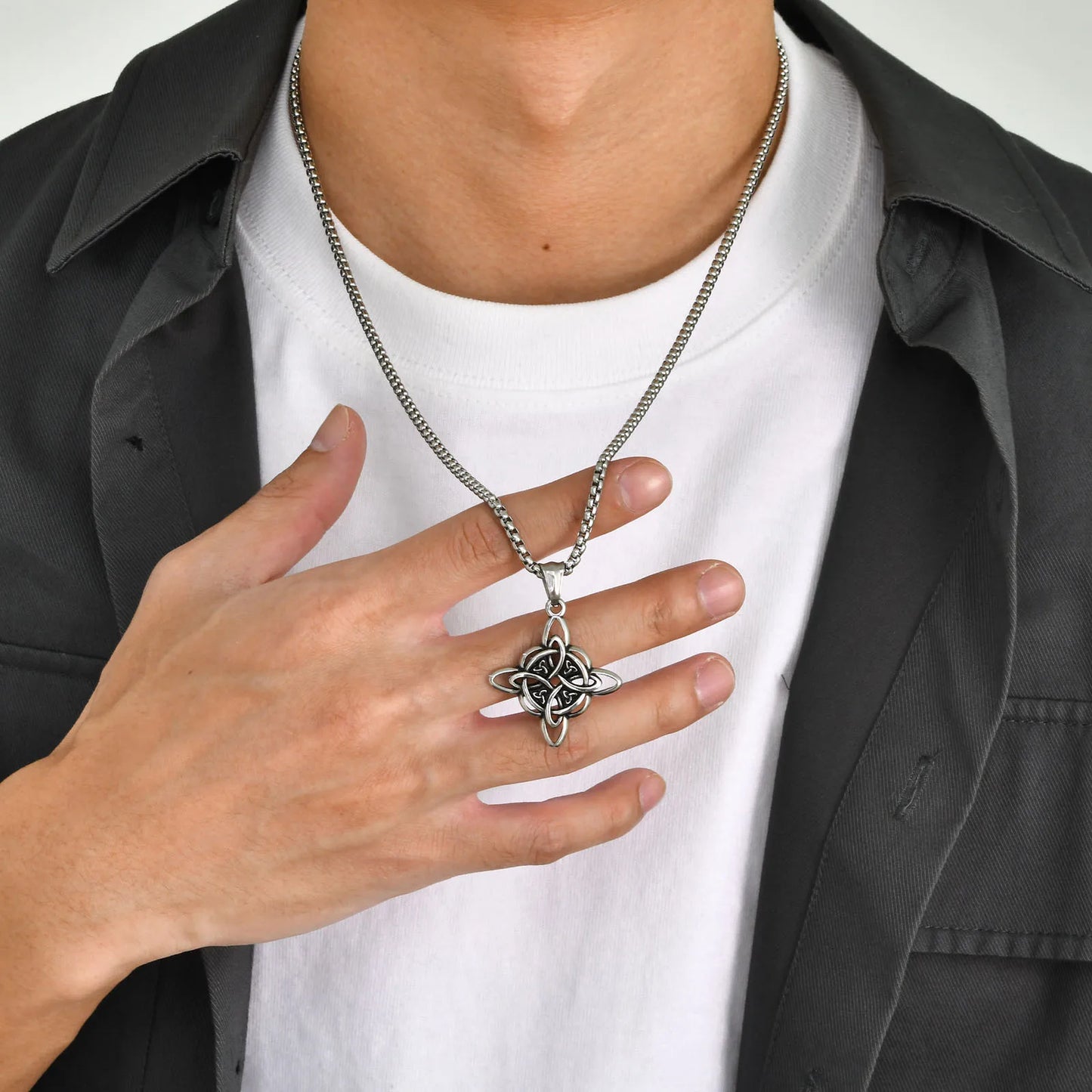Vnox stainless steel Nordic Celtic Knot pendant necklace on a silver chain, worn by a man over a white t-shirt.