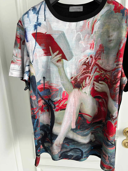T-shirt with artistic design of a nude figure holding a book on a white background