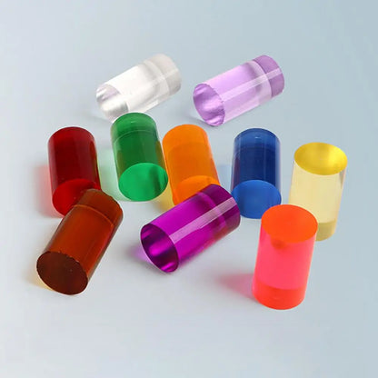 Colorful cylindrical plastic tubes on a light gray background