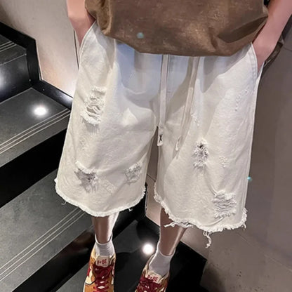 Person wearing white distressed shorts and colorful sneakers on a staircase.