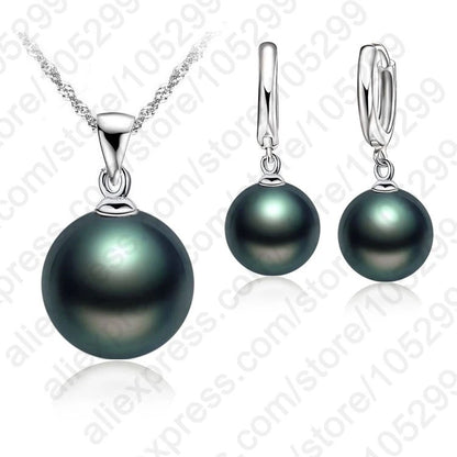 Pearl necklace and earrings set on a white background