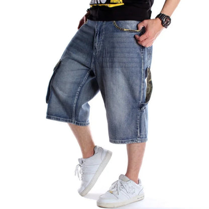 Person wearing blue denim shorts and white sneakers on a white background