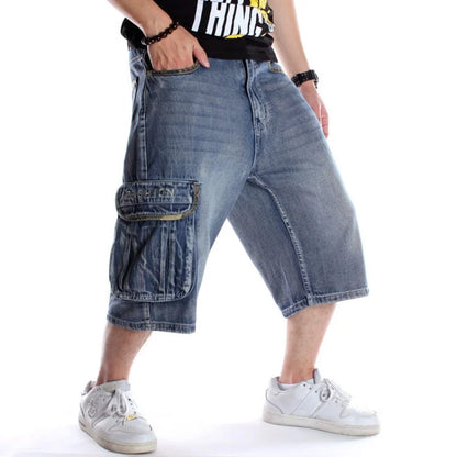 Person wearing blue denim cargo shorts on a white background