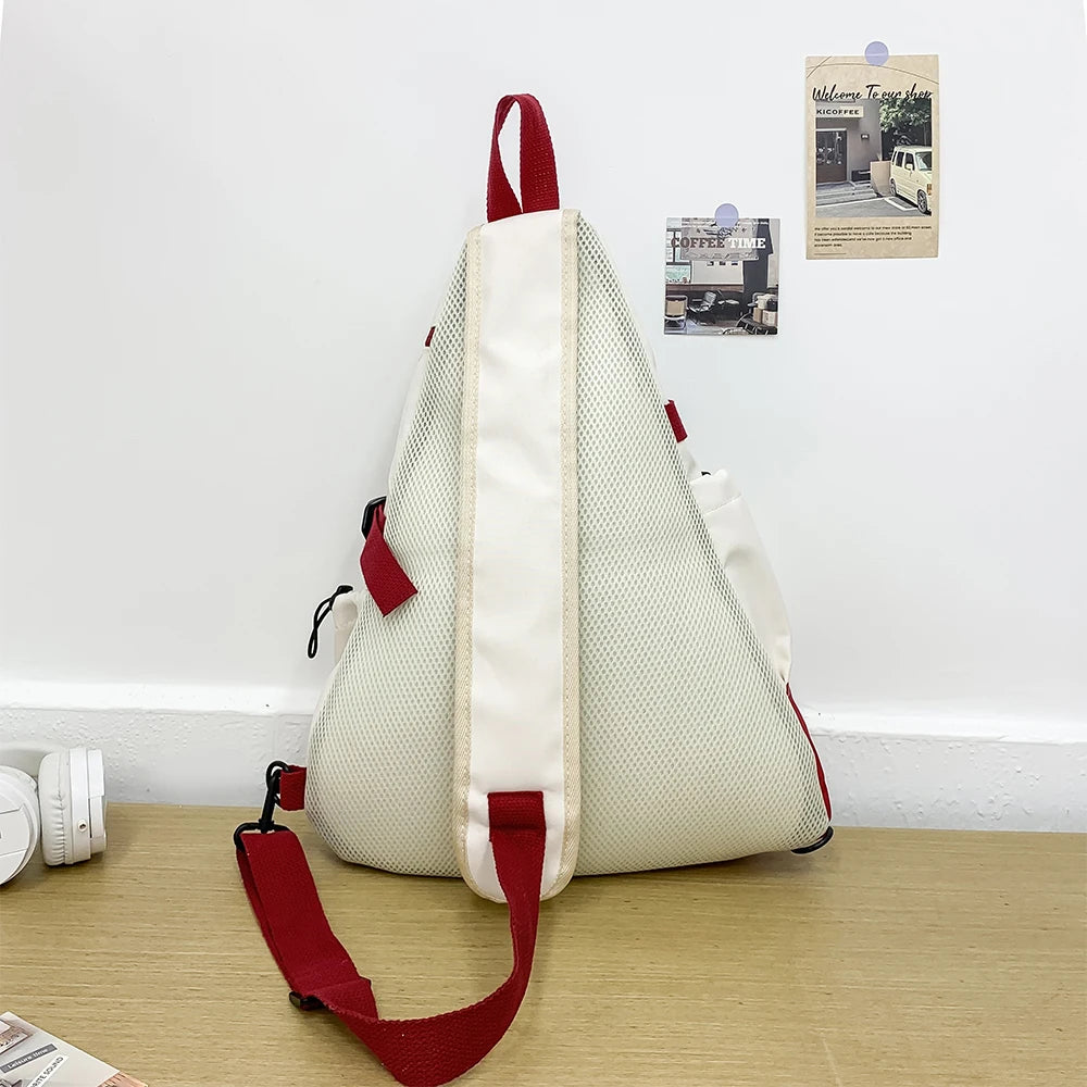 White and red backpack on a wooden surface with a minimal background