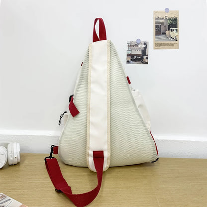 White and red backpack on a wooden surface with a minimal background