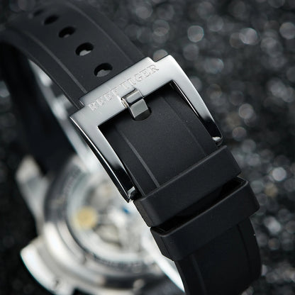 Close-up of a black watch strap with a silver buckle on a blurred background