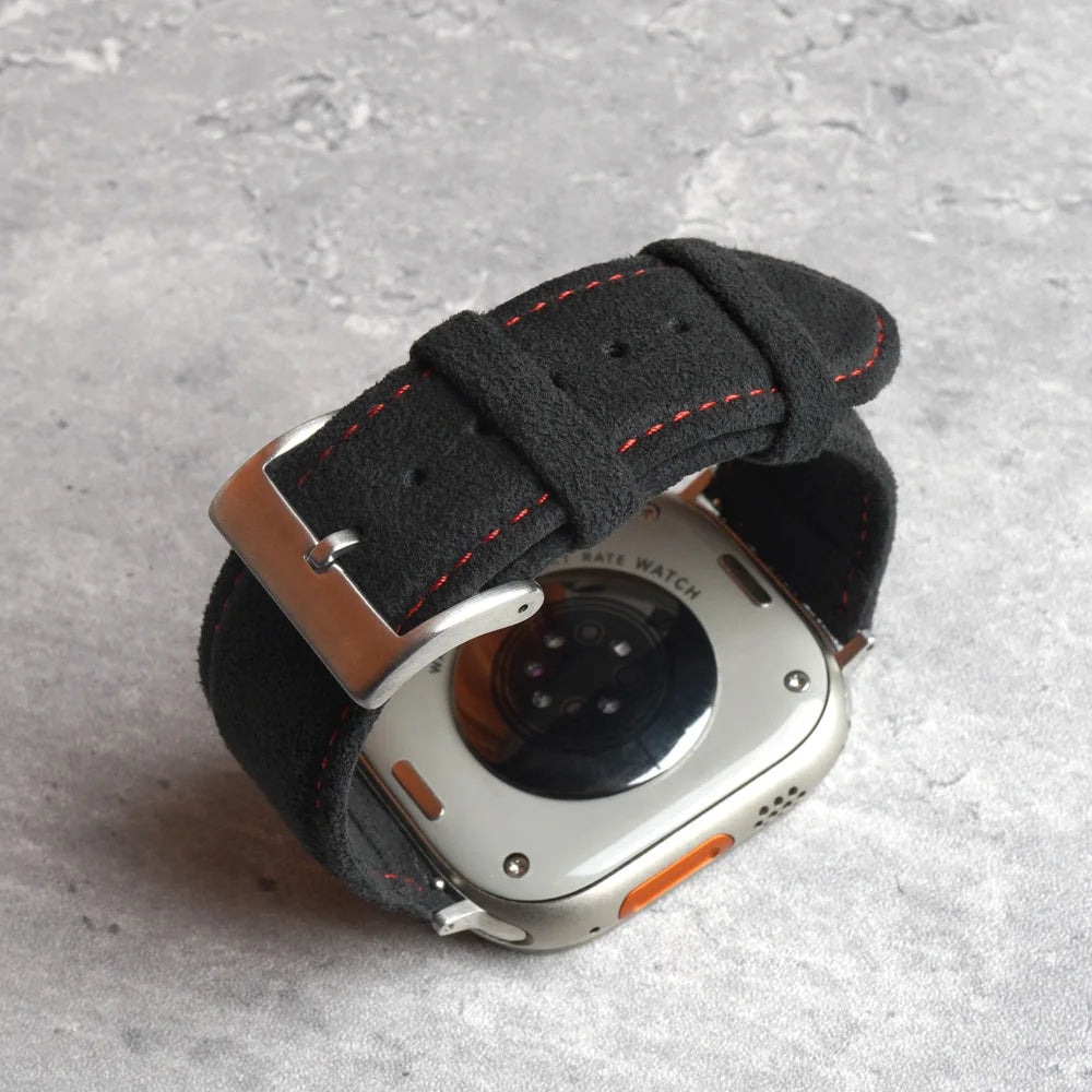 Smartwatch with a black fabric strap on a gray surface