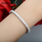 Silver bracelet on a wrist with a blurred red flower in the background, featuring the brand 'BAOSHILIA'.