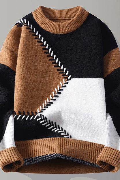 Color-blocked sweater with brown, black, and white pattern on a light gray background