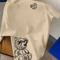 00% reine Baumwolle Herren Cartoon Bär Muster bedrucktes modisches lässiges lockeres Sport Rundhals Kurzarm T-Shirt Oberteil
