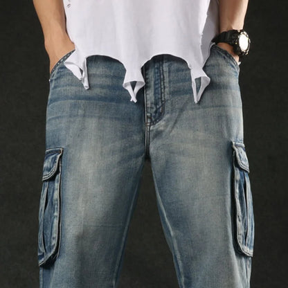 Person wearing blue cargo jeans with a plain background