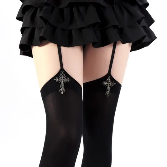 Black stockings with cross designs worn by a person, on a white background