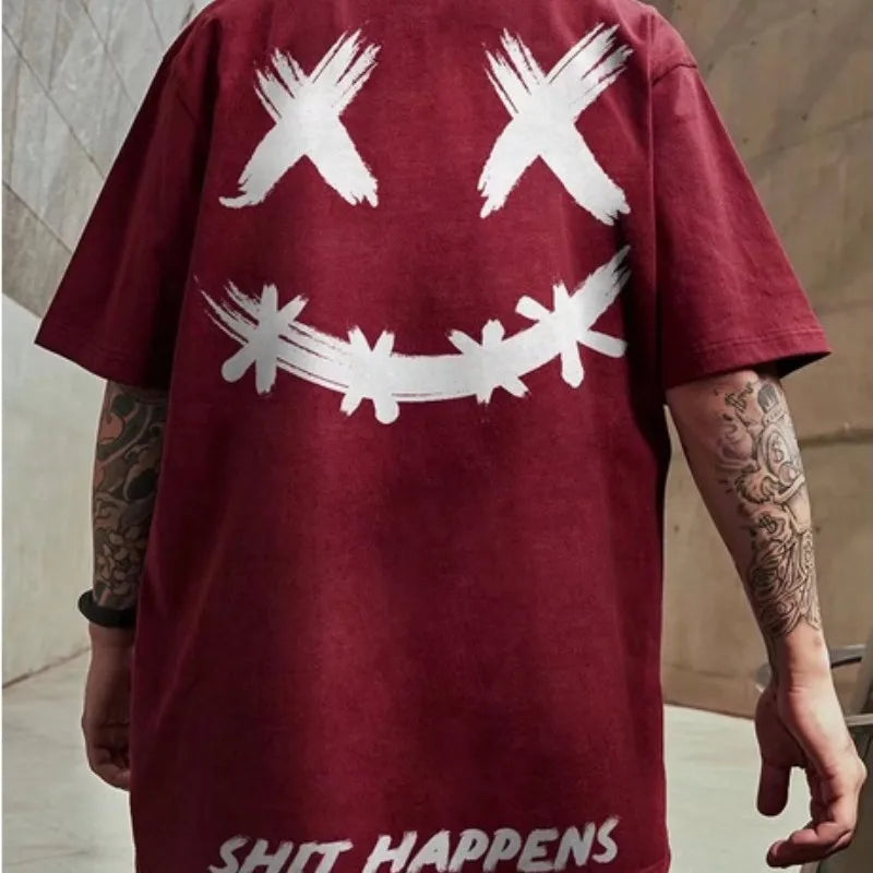 Maroon t-shirt with white graphic design and 'SHIT HAPPENS' text on a neutral background