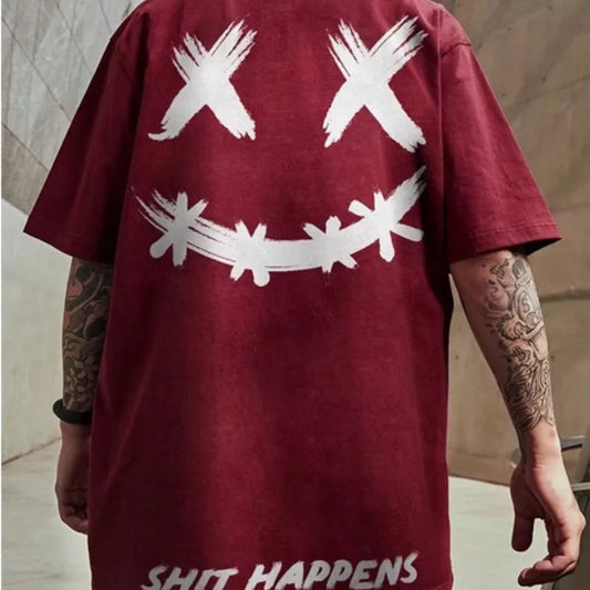 Maroon t-shirt with white graphic design and 'SHIT HAPPENS' text on a neutral background