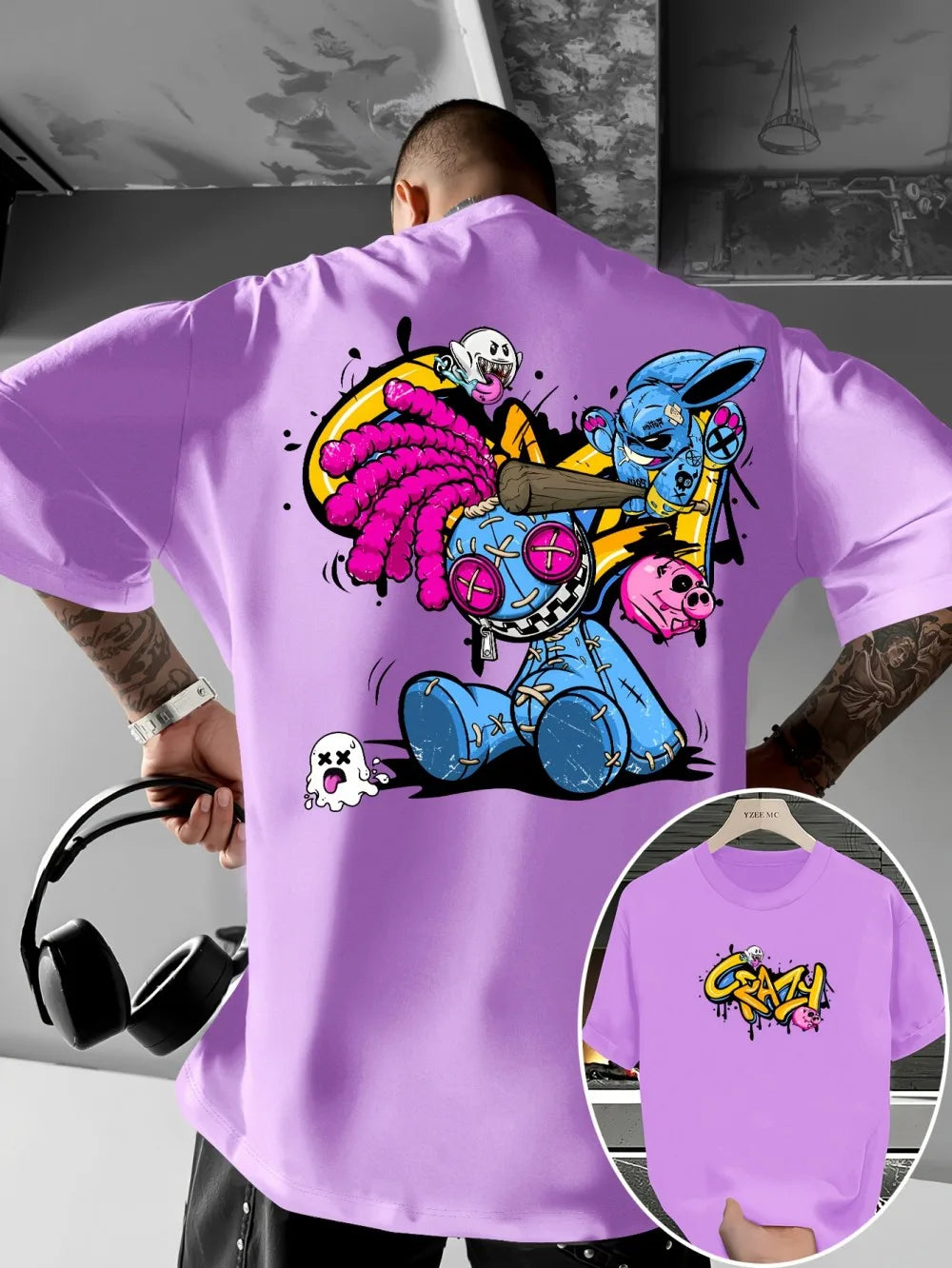 Person wearing a purple t-shirt with colorful graphic design on the back, with a close-up of the design on the shirt.