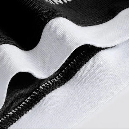 Close-up of a black and white textured fabric with a zipper detail.
