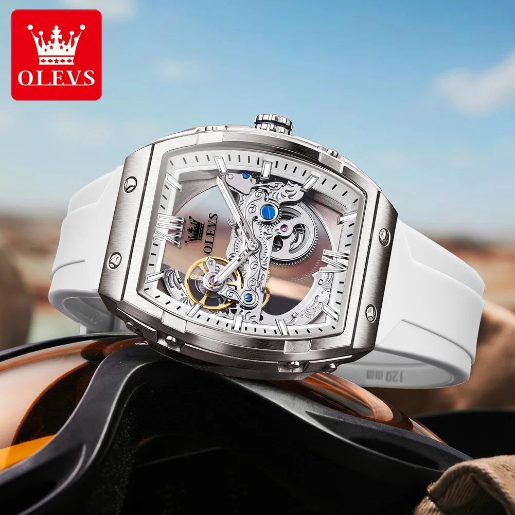 Silver OLEVS watch with white strap on a blurred background