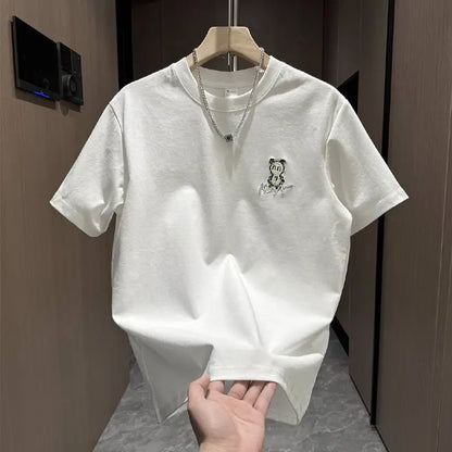 White t-shirt with a small logo on a hanger against a neutral background