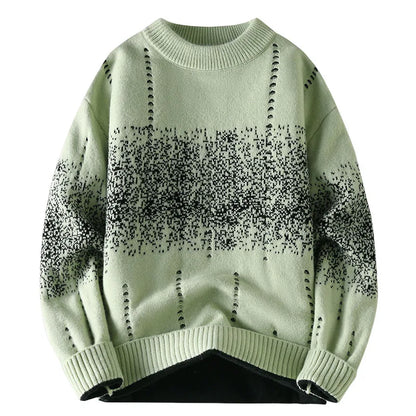 Light green sweater with black speckle pattern on a white background