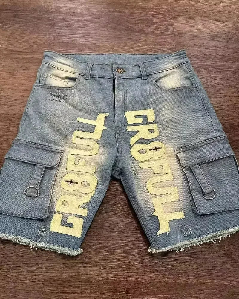 Denim shorts with 'GR8FUL' branding on a wooden surface