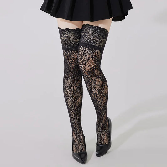 Black lace stockings worn with a black skirt and shoes on a white background