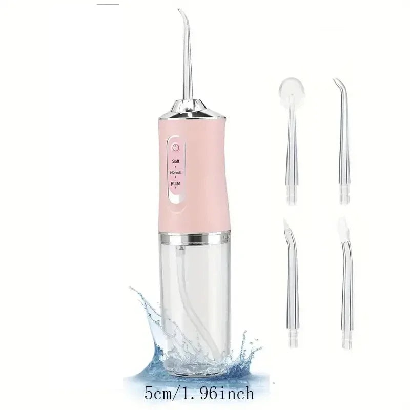 Pink dental water flosser with additional nozzles on a white background