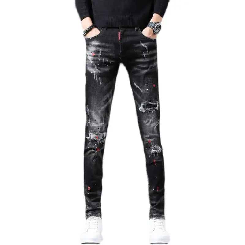 Black distressed jeans worn by a person on a white background