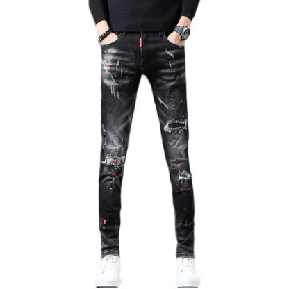 Black distressed jeans worn by a person on a white background