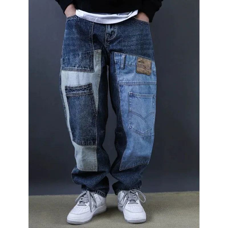 Person wearing a pair of patchwork jeans with a dark background