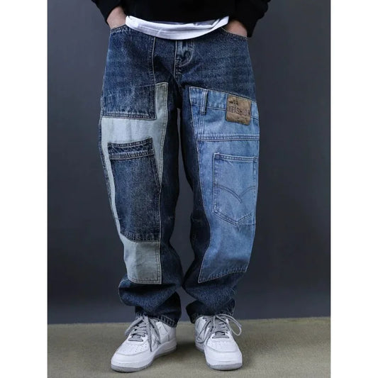 Person wearing a pair of patchwork jeans with a dark background