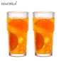 Two glasses of orange juice with a white background and 'KEMORELA' branding.
