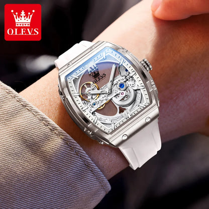 Silver watch with intricate design on a wrist, brand 'OLEVS' visible