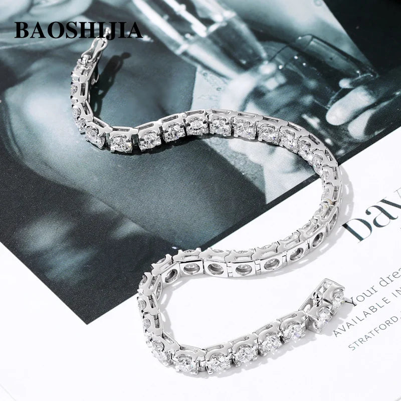 Silver bracelet with clear stones on a magazine background, featuring the brand 'BAOSHIJIA'.